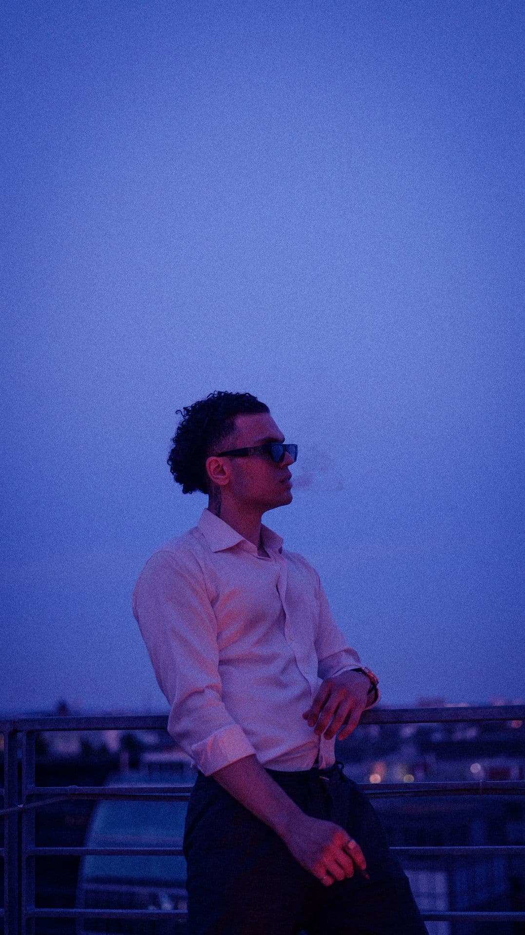 Confidence leaning on the fence of rooftop