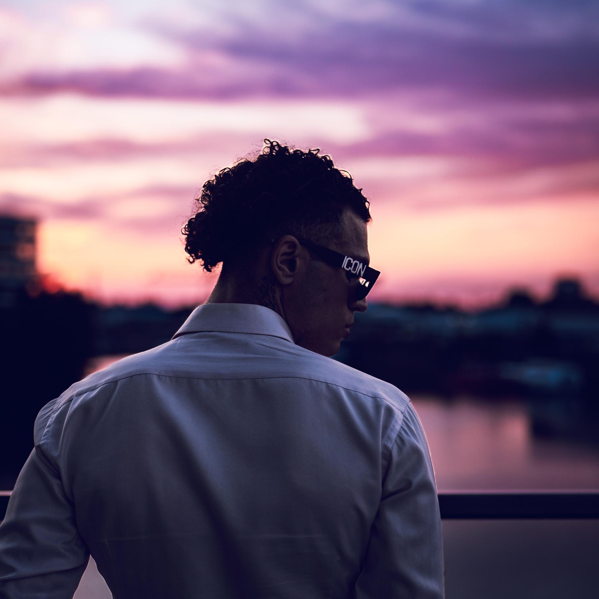 looking over shoulder with sunset in the background